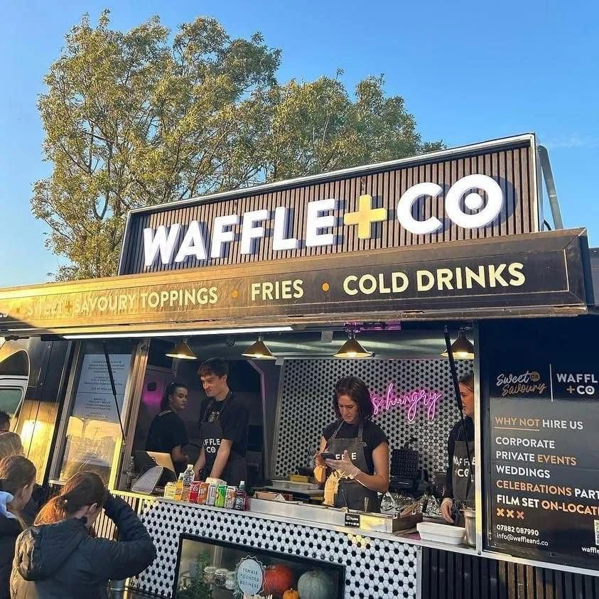 The Waffle and Co street food truck serving under a blue sky